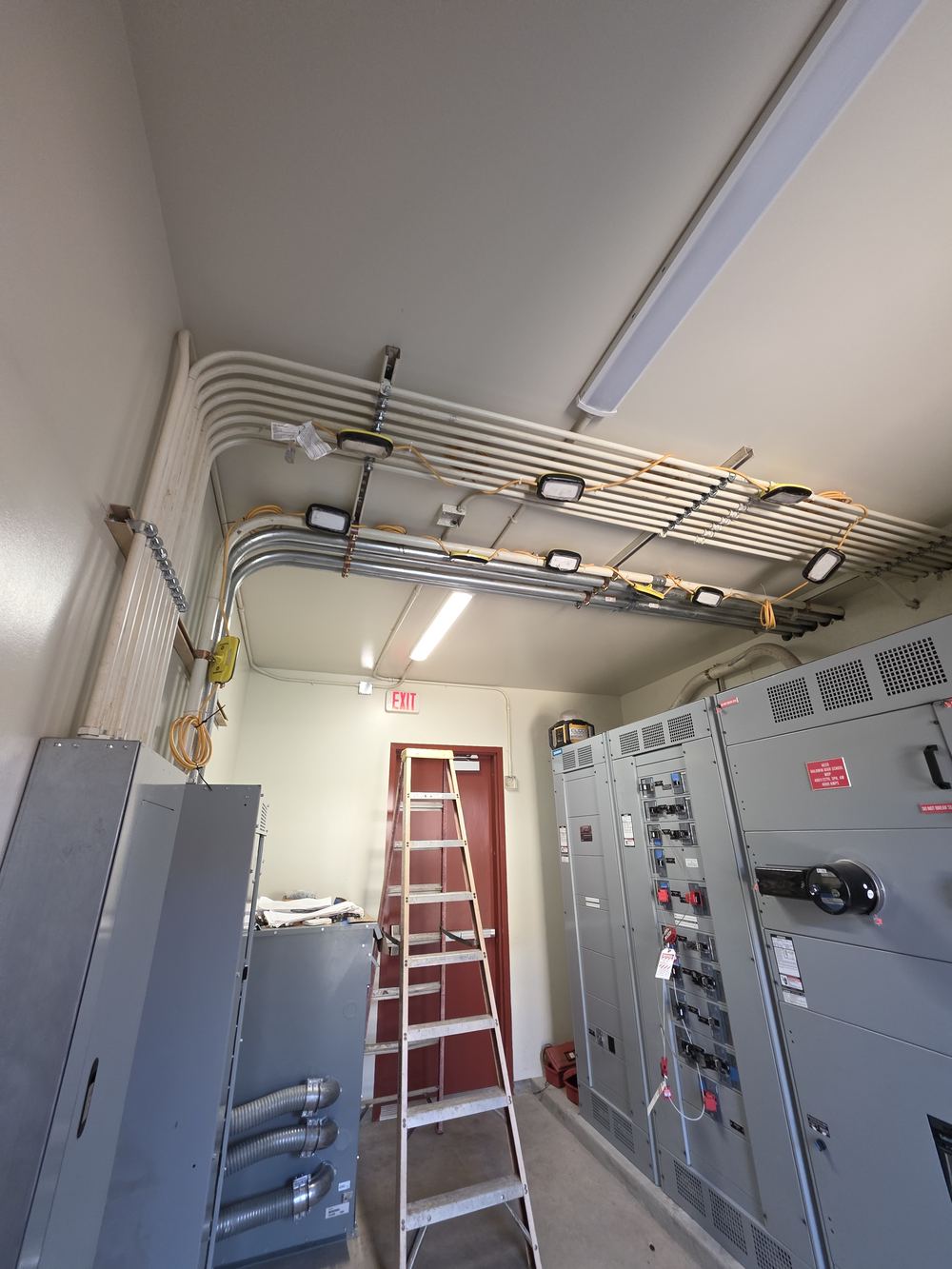 Main electrical room with switchgear and conduit