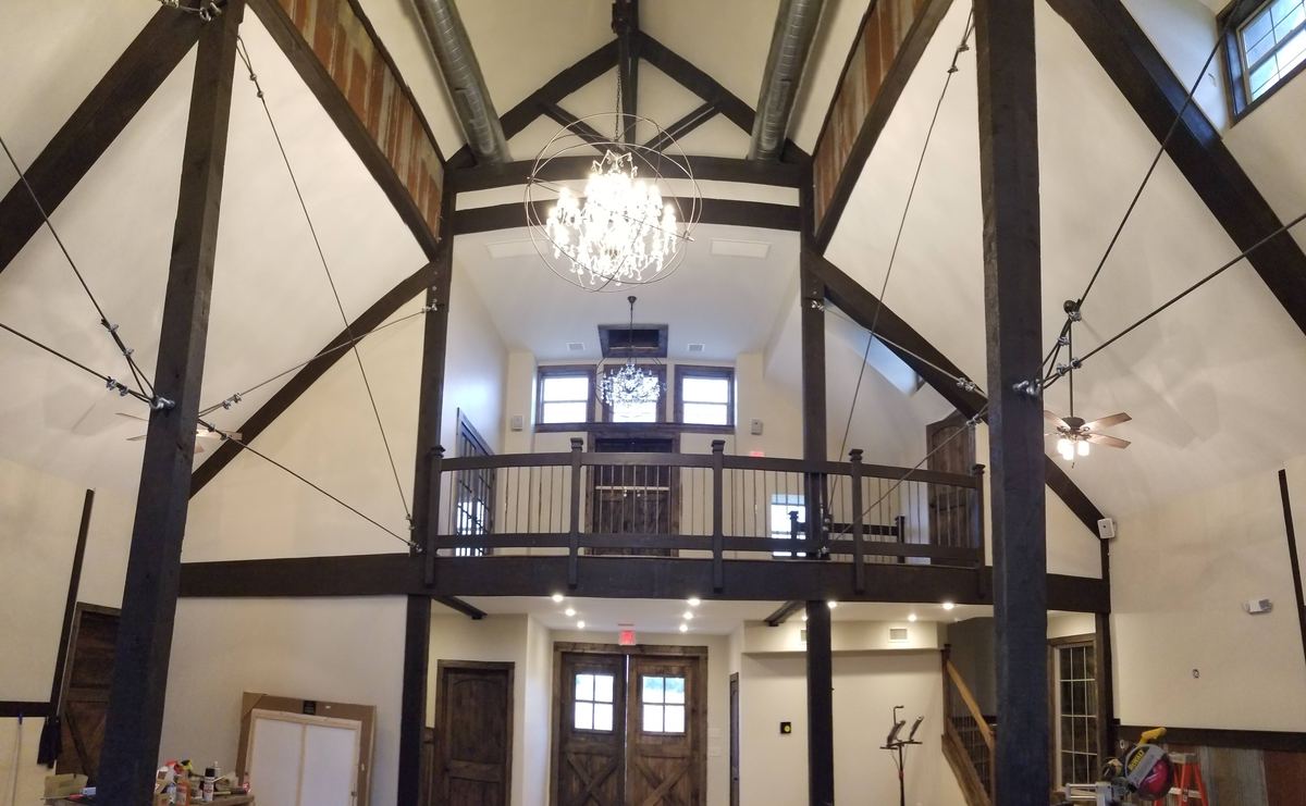 Timber-frame interior with loft and chandelier